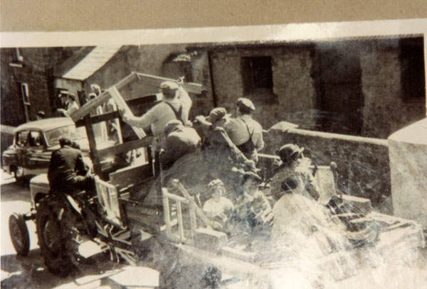 Copy of a group of people on a tractor building the village hall 1955